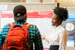 Nia Cayenne (right) presents her research project to attendees at the Undergraduate Symposium hosted in Varsity Hall at Union South at the University of Wisconsin-Madison on April 13, 2017. The annual event showcases student-led research, creative endeavors and service-learning projects. (Photo by Bryce Richter / UW-Madison)